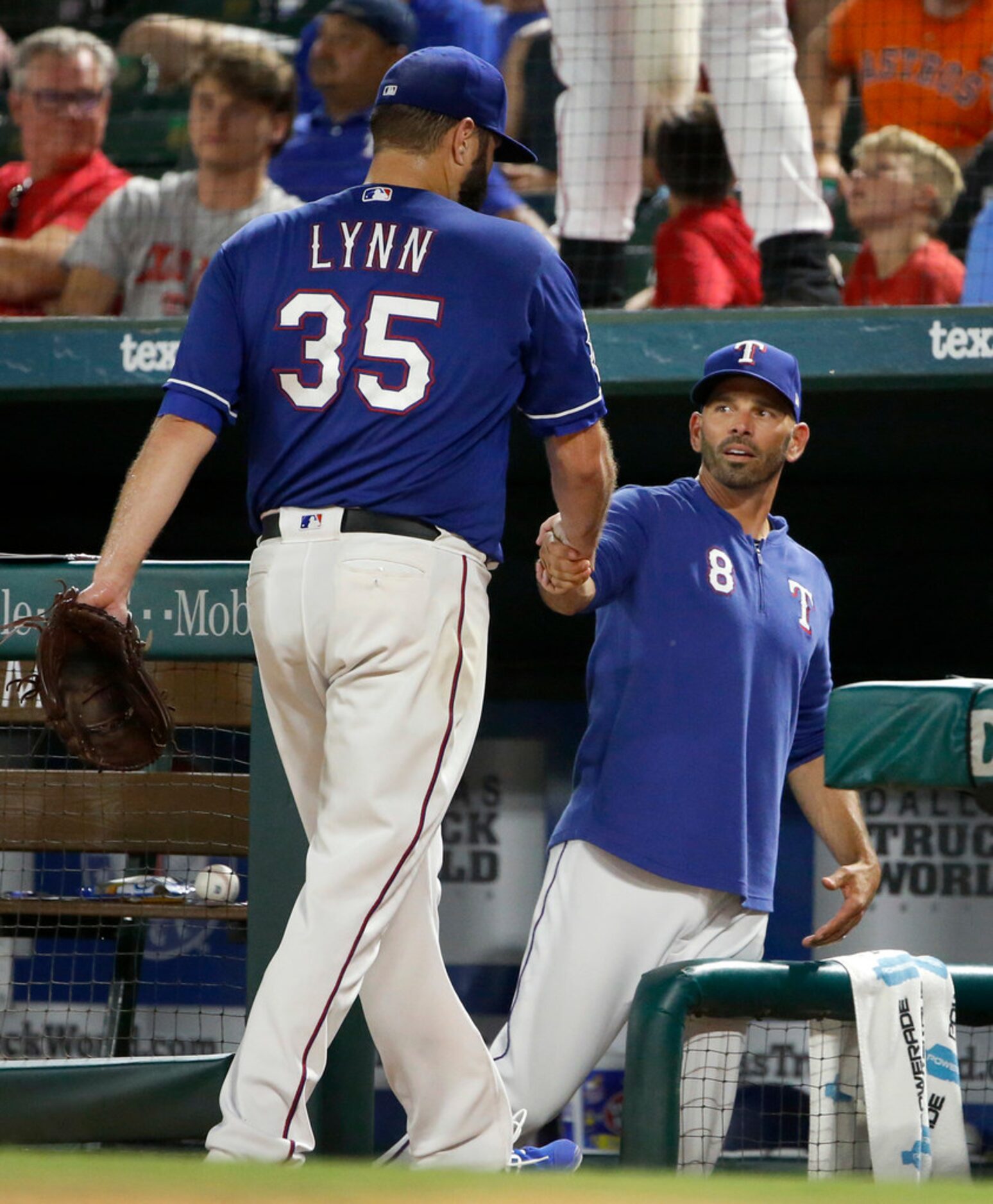 Texas Rangers starting pitcher Lance Lynn (35) is congratulated by manager Chris Woodward on...