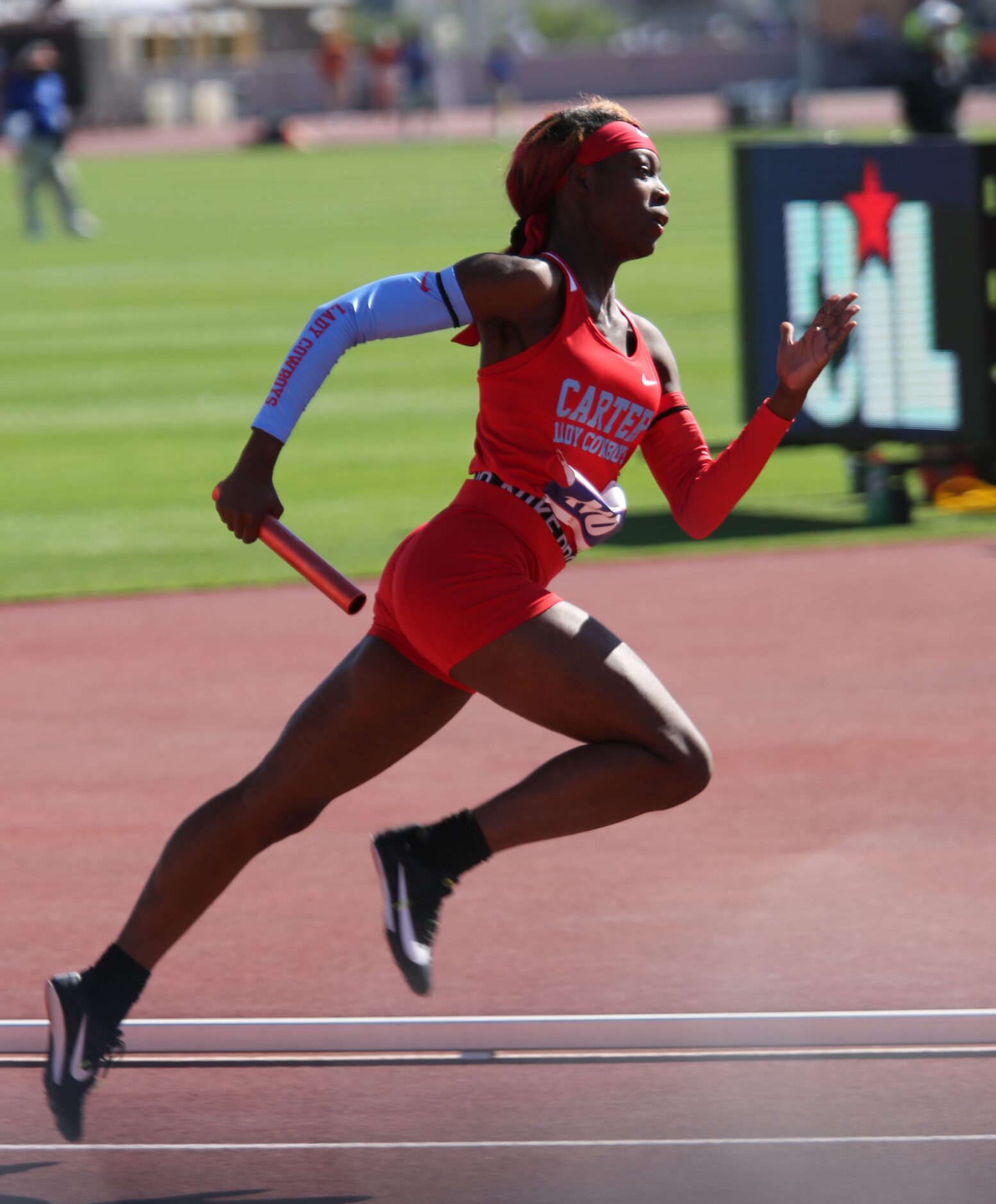 Carter's Jada Smith runs with the baton during their 4A girls 4x100 relay  at the UIL state...