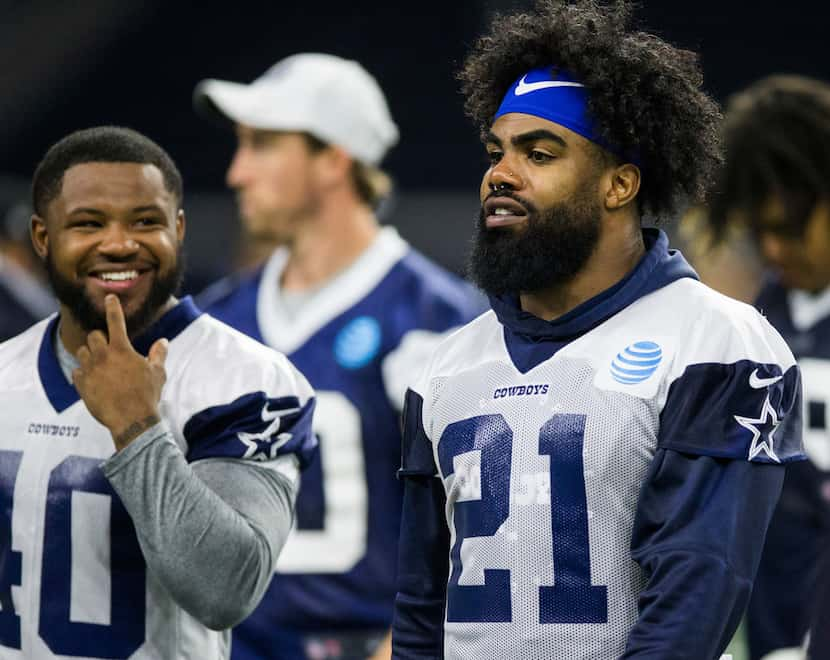 Dallas Cowboys running back Mike Weber (40) talks with running back Ezekiel Elliott (21)...