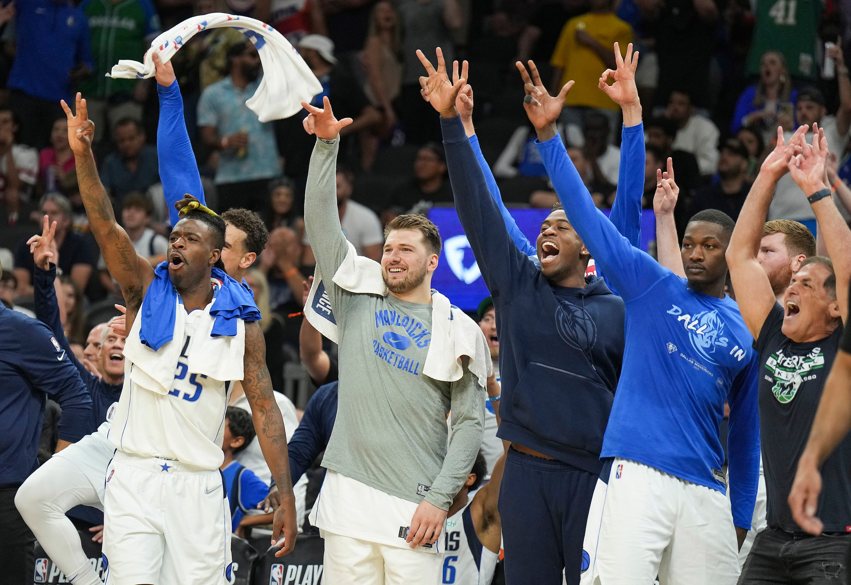 Dallas Mavericks players (from left) Reggie Bullock (25), Dwight Powell (behind Bullock),...