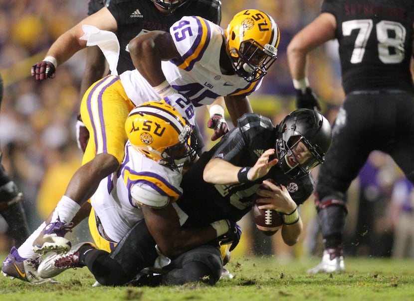 Texas A&M Aggies quarterback Kyle Allen (10) is sacked by LSU Tigers defensive end Lewis...