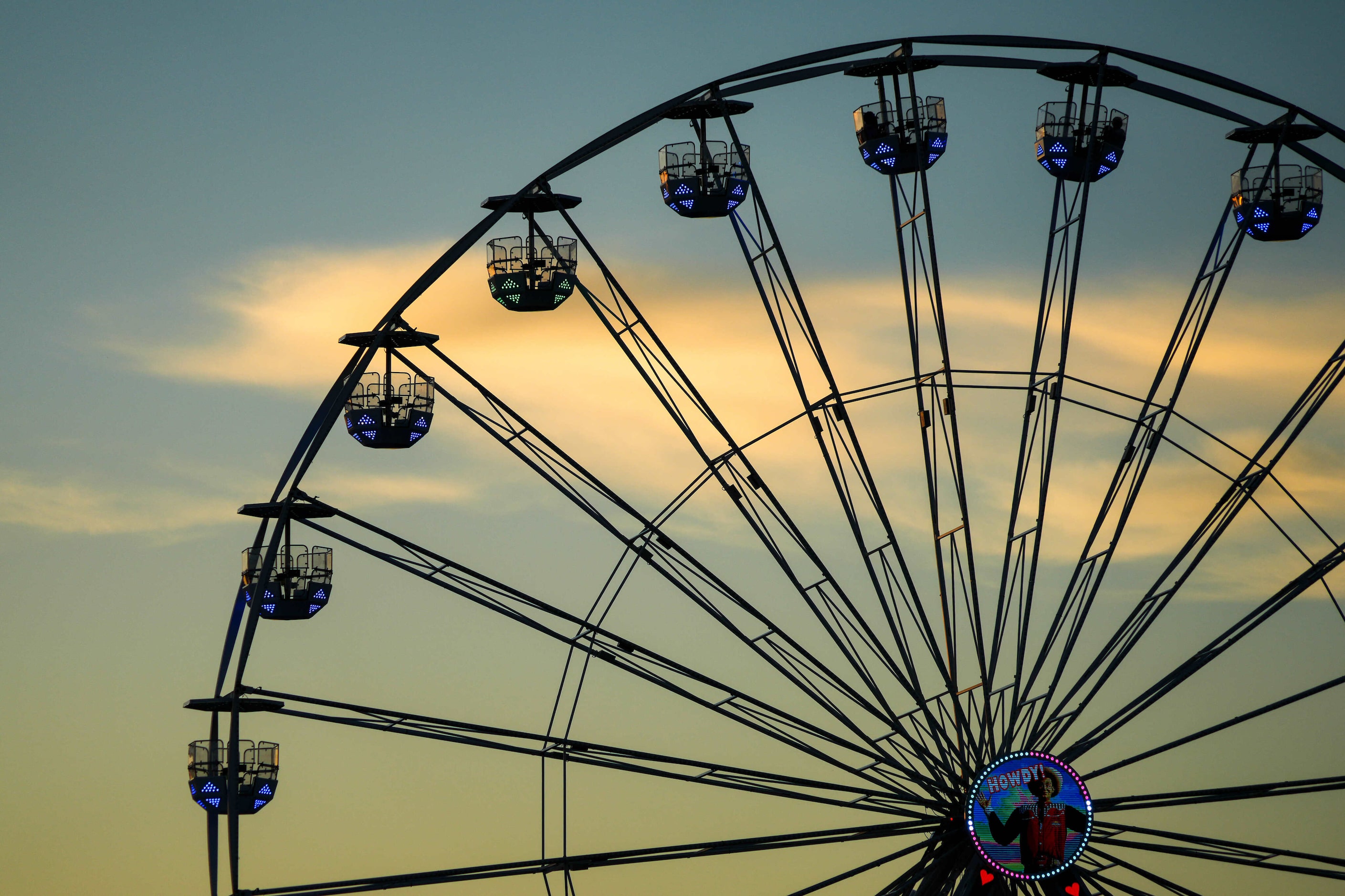 Night falls behind a Ferris wheel at the State Fair of Texas on Sunday, Sept. 29, 2024, in...