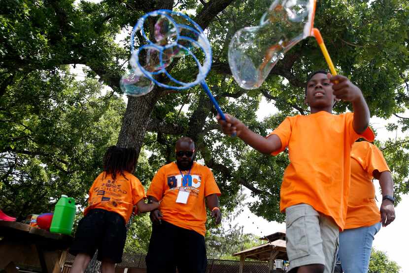 Olivia Johnson (right), 9, played with bubbles during the Black Trans Advocacy Coalition's...