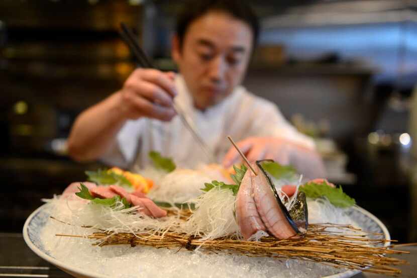 Chef Yutaka Yamato prepares a sashimi special at Yutaka Sushi Bistro in Dallas on March 25,...