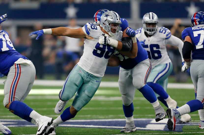 Dallas Cowboys defensive tackle Tyrone Crawford (98) rushes against New York Giants...