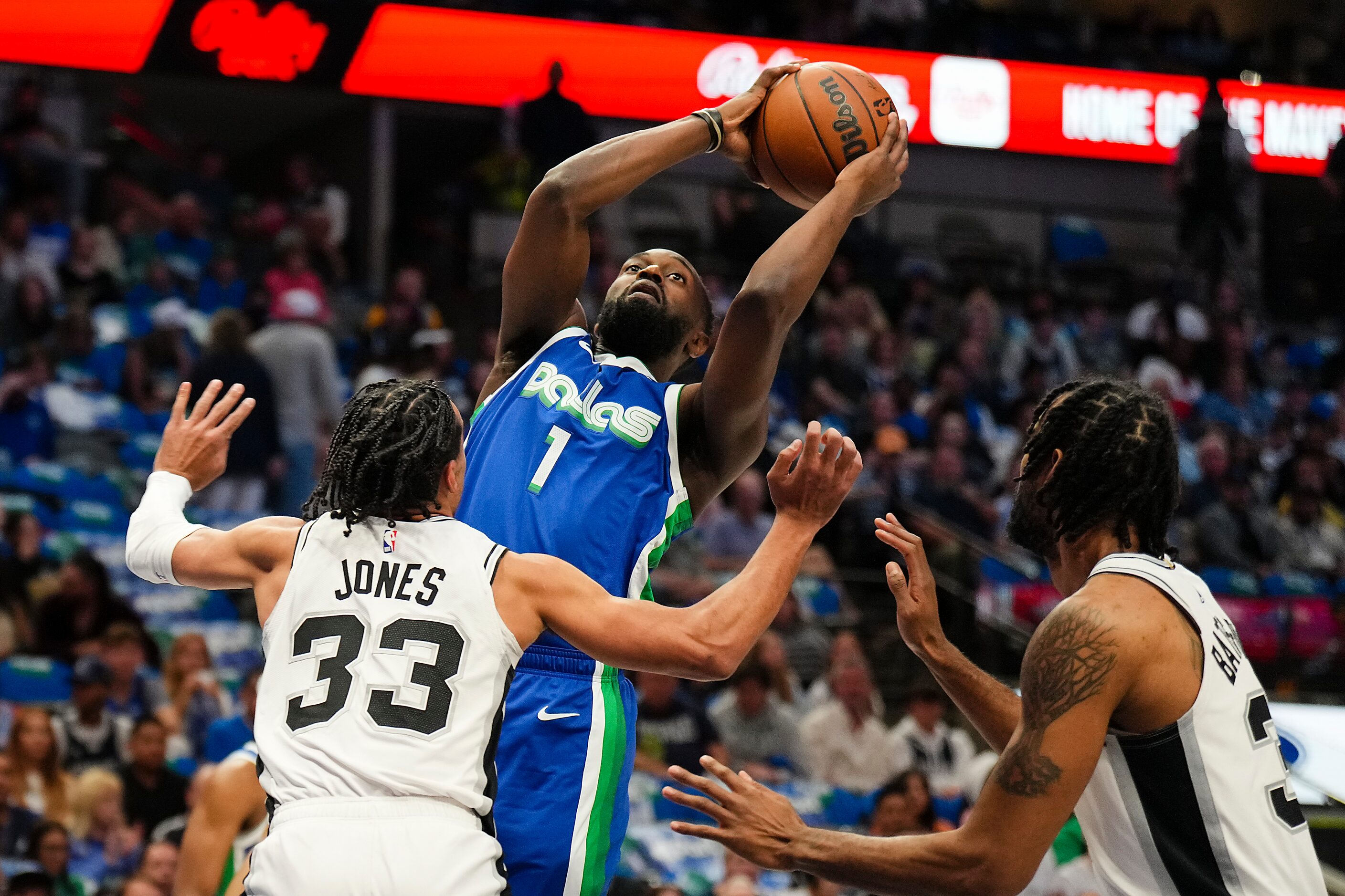 Dallas Mavericks guard Theo Pinson (1) shoots over San Antonio Spurs guard Tre Jones (33)...