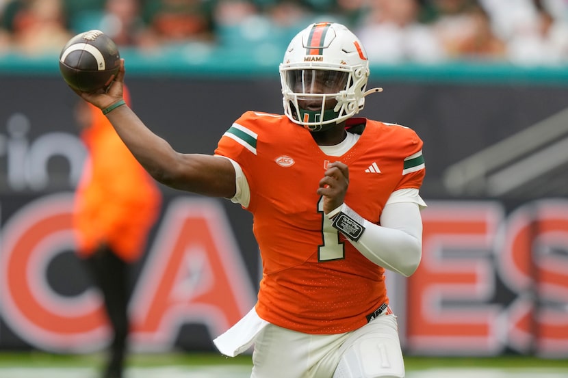 Miami quarterback Cam Ward (1) throws during the first half of an NCAA college football game...