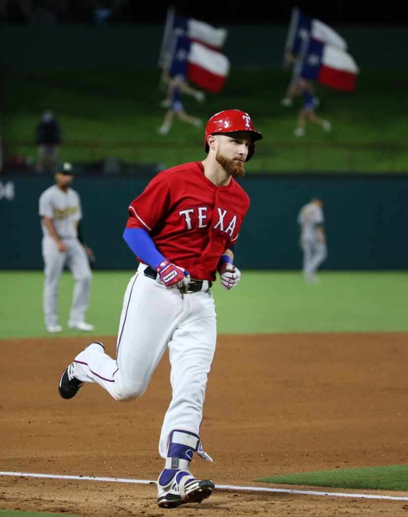 Rangers catcher Jonathan Lucroy (25) rounds the bases after hitting a solo home run in the...