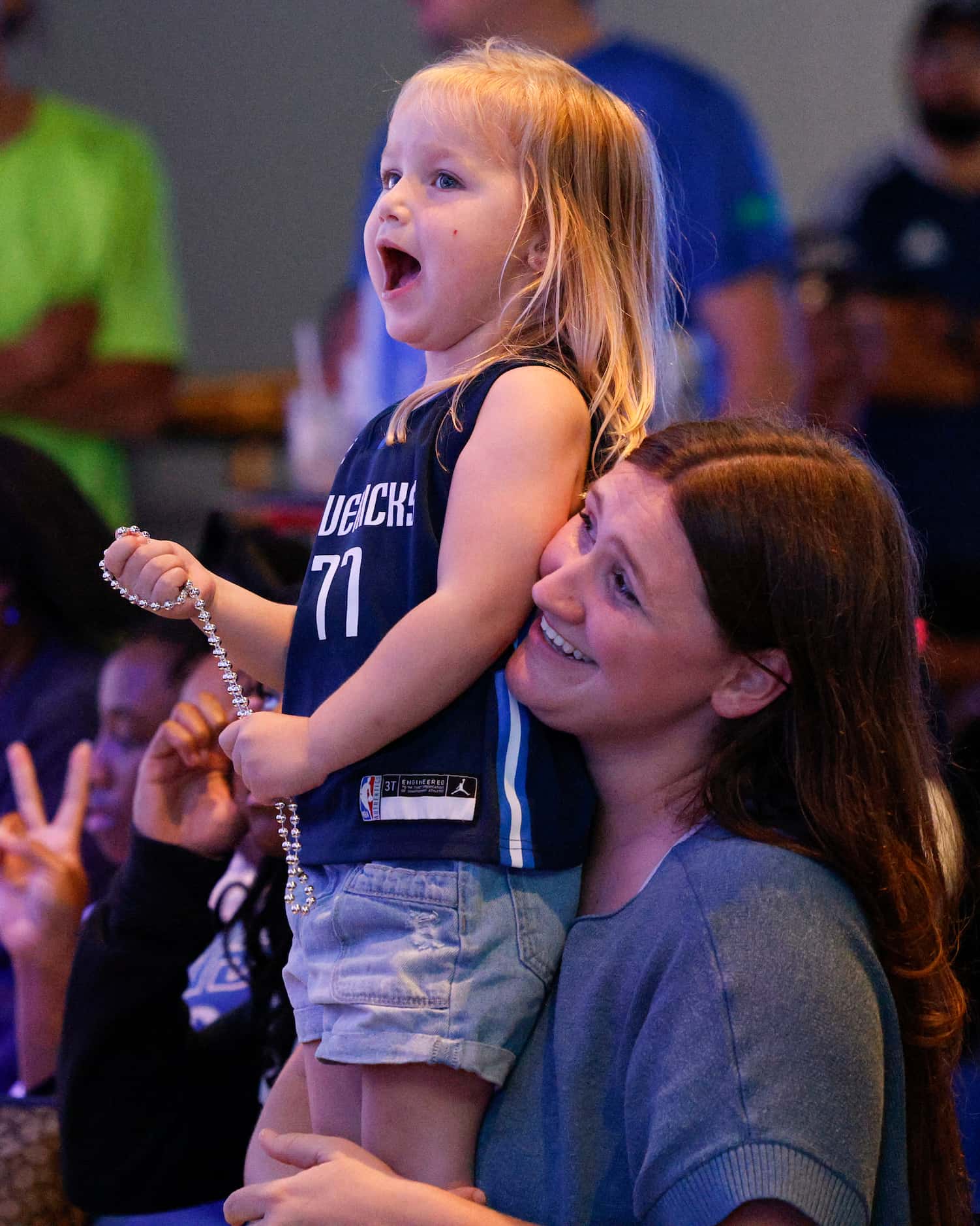 Aubrei Davis holds her three-year-old daughter Theia Davis during a 2023 NBA Draft watch...