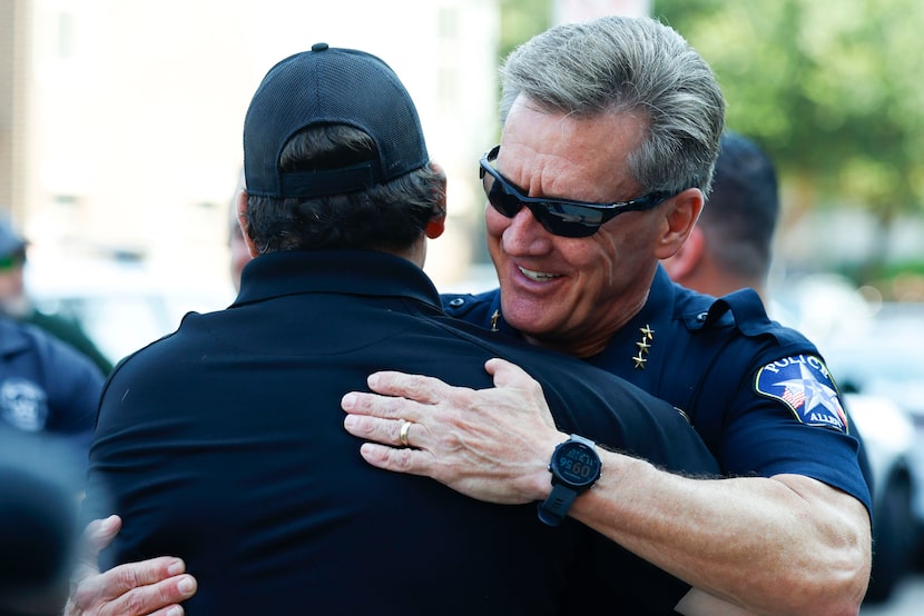 Allen Police Chief Steve Dye (right) greets officers as they gather for a caravan down to...