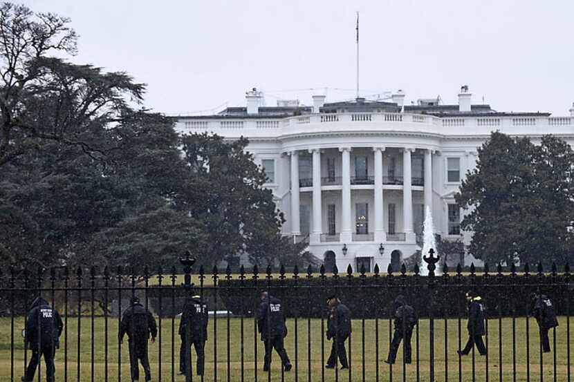 U.S. Secret Service agents comb the White House grounds on Jan. 26 after an unmanned aerial...