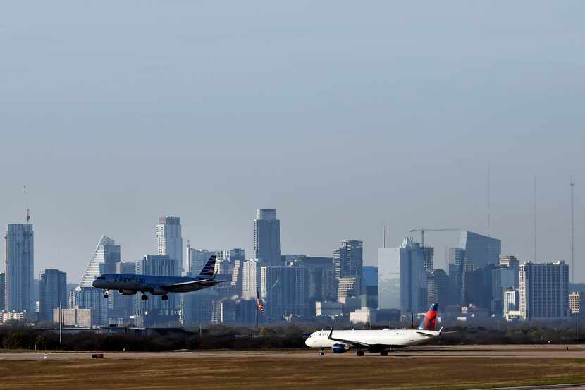 An American Airlines jet lands at Austin-Bergstrom International Airport before the Austin,...