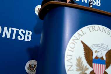 The National Transportation Safety Board logo and signage are seen at a news conference at...