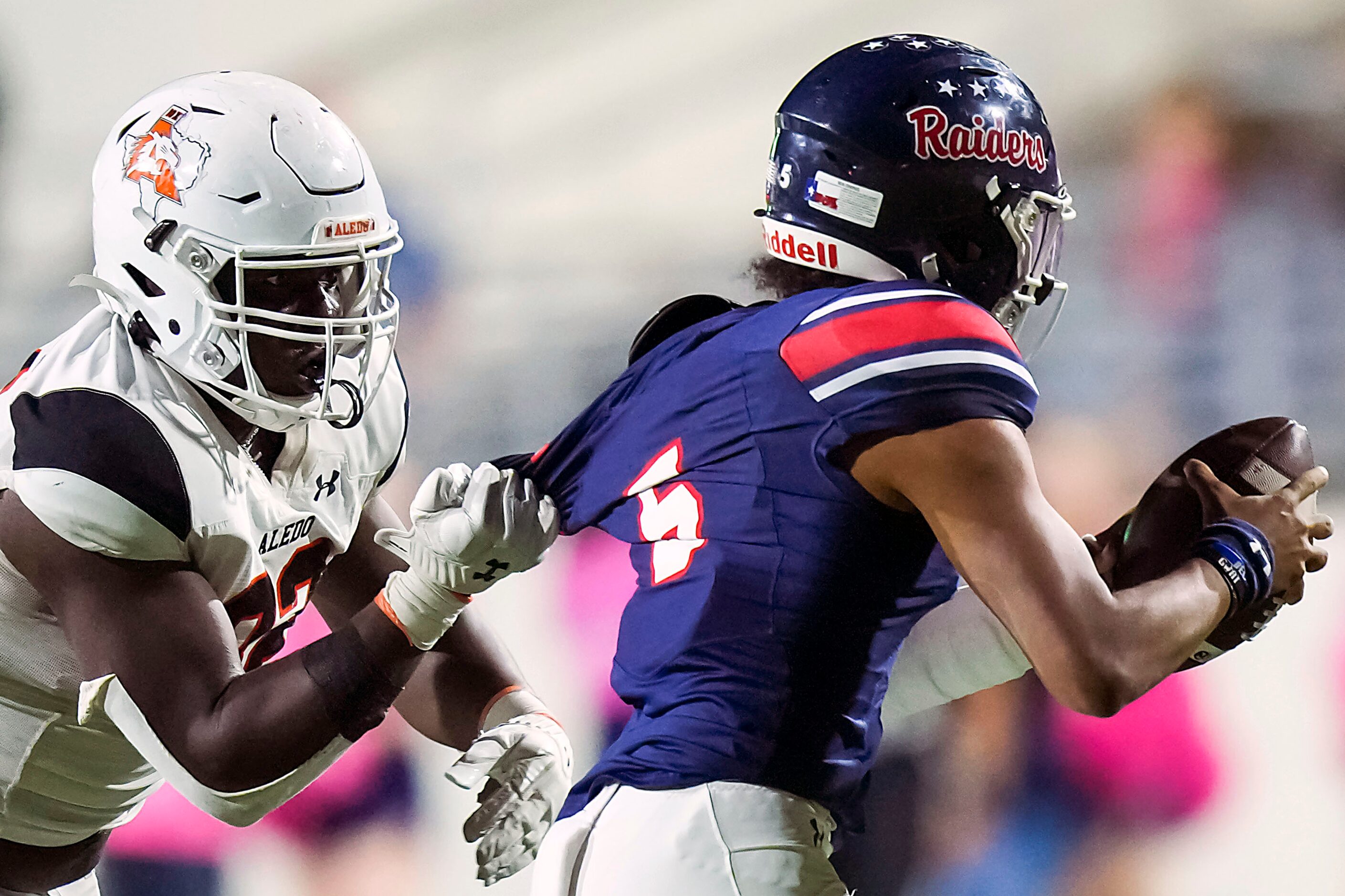 Denton Ryan quarterback Khalon Davis (5) tries to pass as he is pulled down by Aledo...