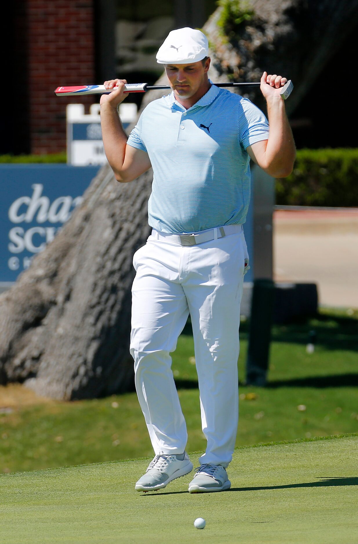 PGA Tour golfer Bryson DeChambeau
reacts after missing a birdie putt on No. 18 leaving him...