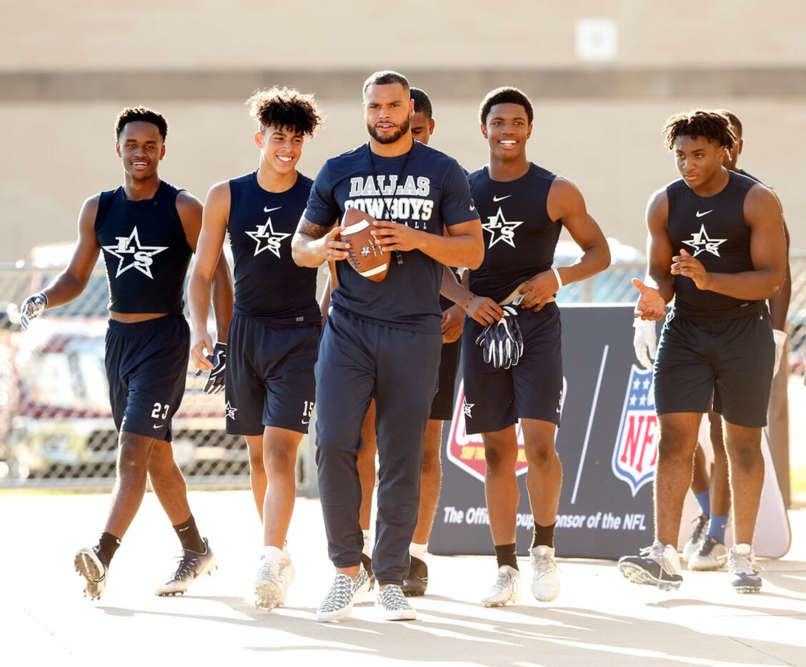 Dallas Cowboys quarterback Dak Prescott (center) joined Lone Star High School football...