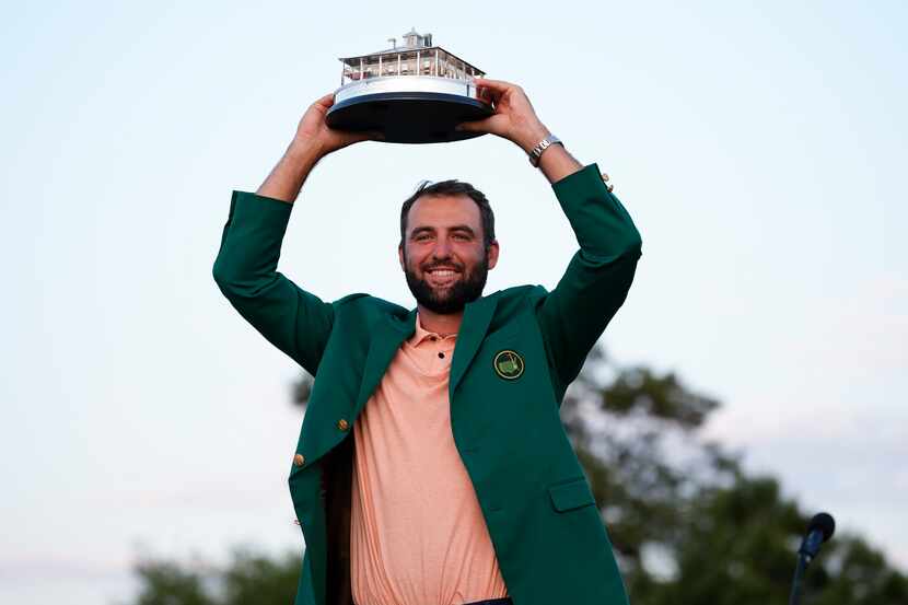 Scottie Scheffler holds the trophy after winning the Masters golf tournament at Augusta...