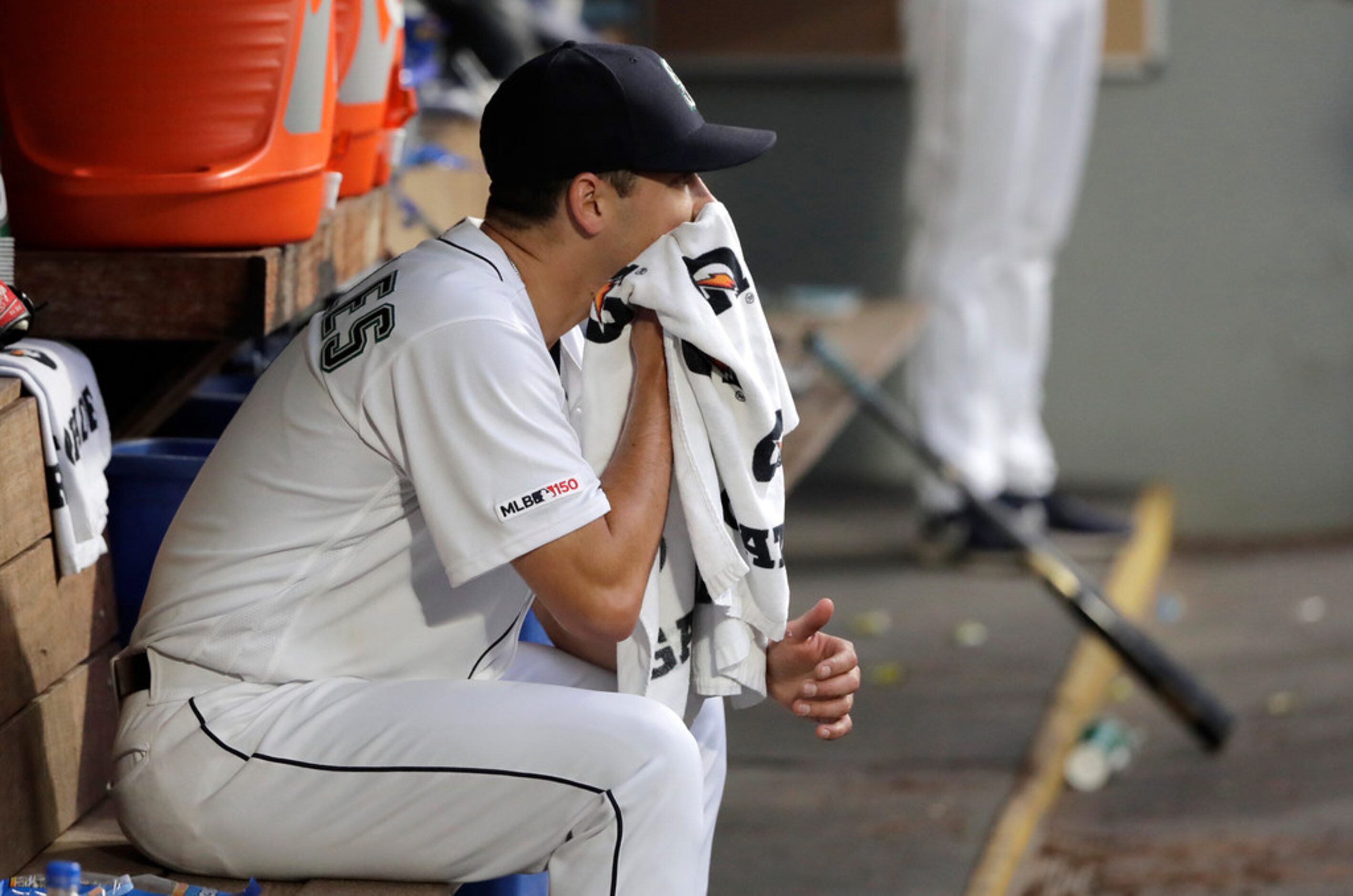 Seattle Mariners starting pitcher Marco Gonzales sits in the dugout after being pulled from...