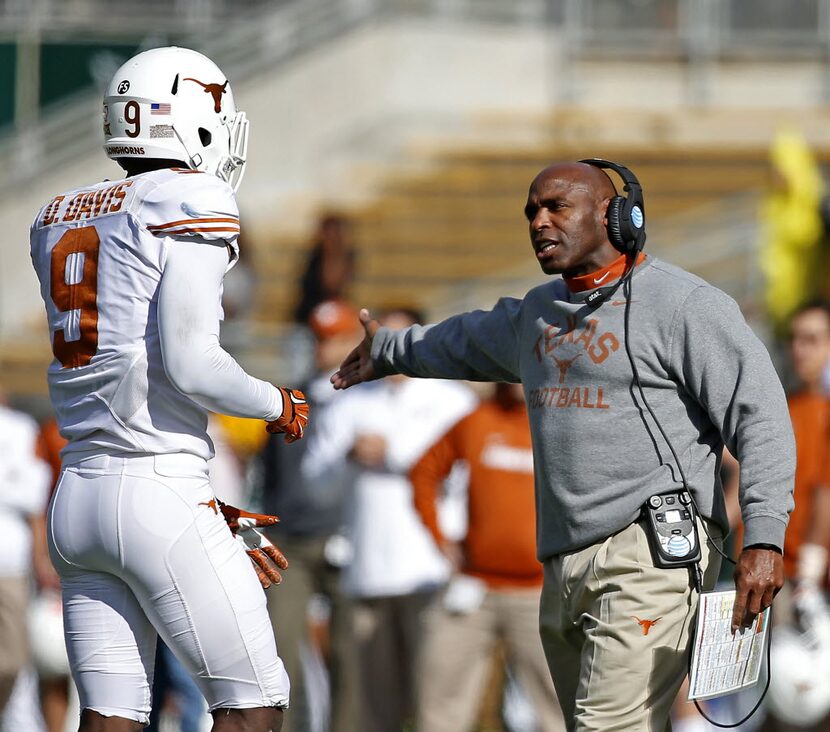 Texas head coach Charlie Strong, right, talks with cornerback Davante Davis (9) during the...