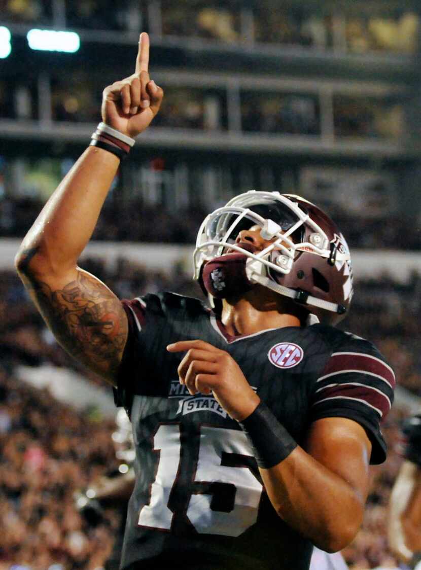 Mississippi State quarterback Dak Prescott (15) points skyward in remembrance of his mother...
