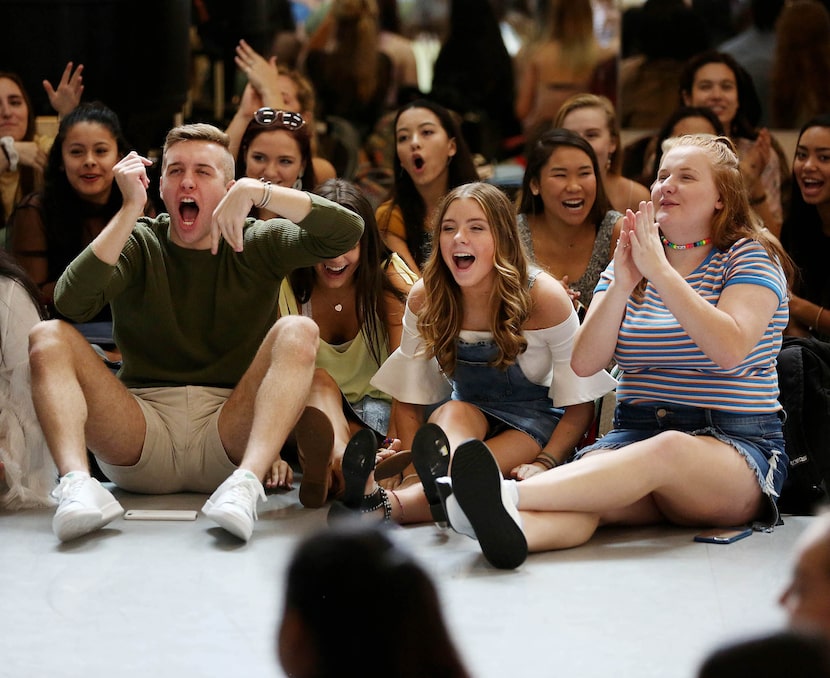 Dance students (from left) Luke Qualls, Kennedy Huff and Shelby Flowers, all seniors, cheer...