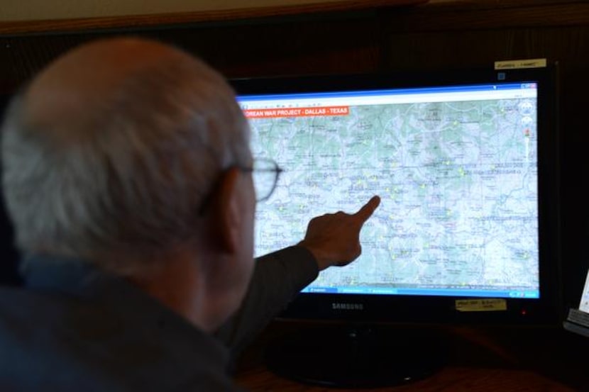 Hal Barker  points out a battlefield on a map of Korea. Hal and his brother Ted Barker are...