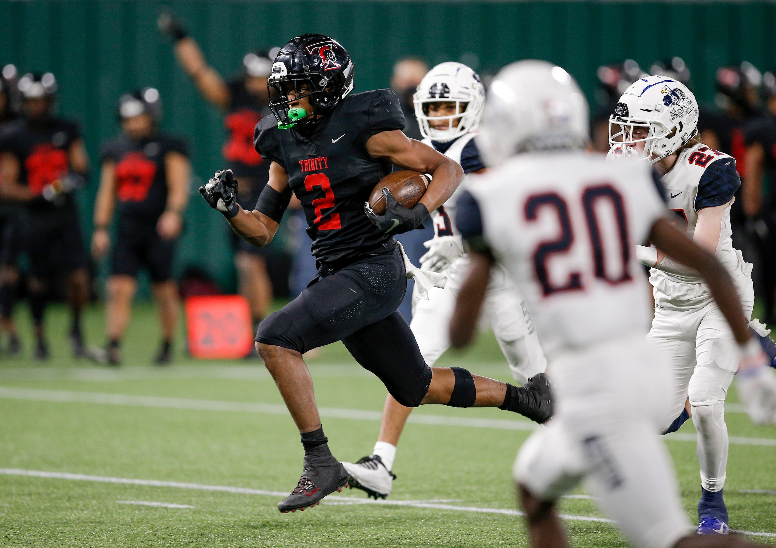 Euless Trinity junior running back Ollie Gordon (2) breaks past the Allen defense to score a...