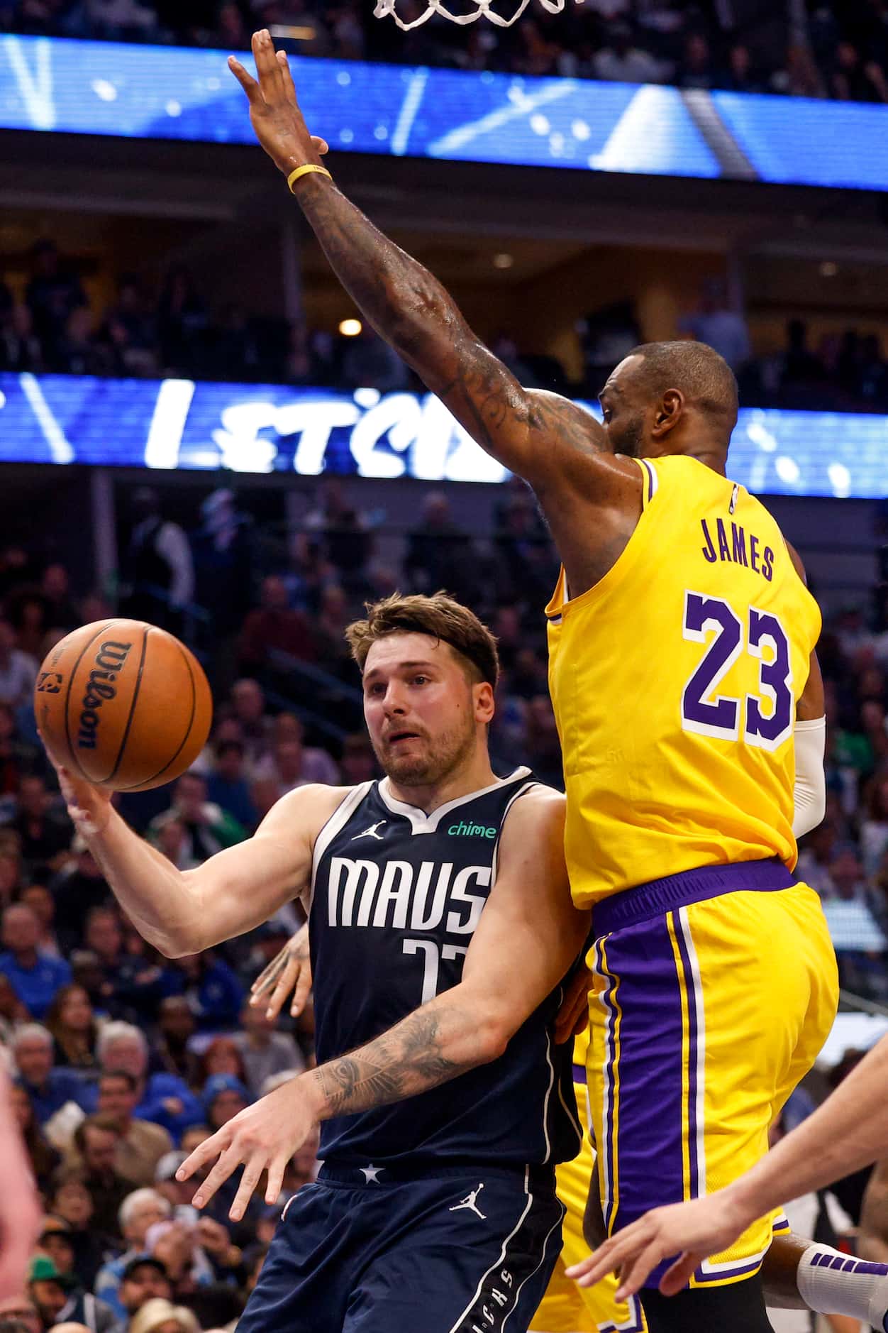 Dallas Mavericks guard Luka Doncic (77) passes the ball around Los Angeles Lakers forward...