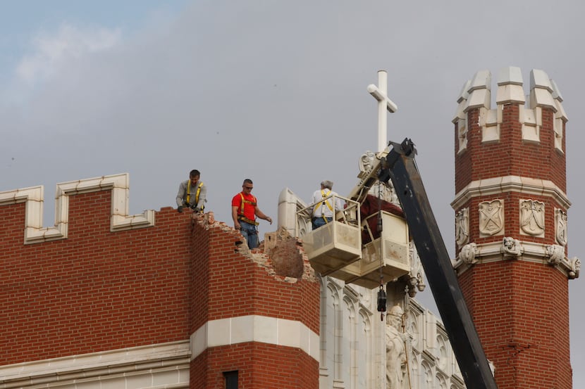 FILE - In this Nov. 6, 2011 file photo, maintenance workers inspect the damage to one of the...