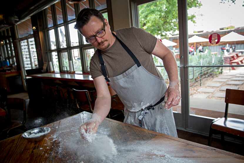 Chef Tim Byres flours a table as he makes buttermilk biscuits at Chicken Scratch restaurant.