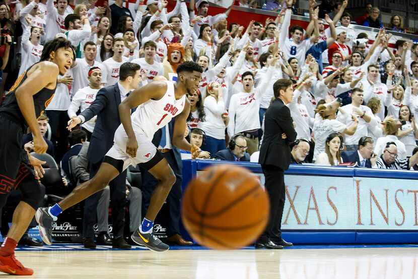 SMU guard Shake Milton (1) heads down the court as the crowd celebrates one of his baskets...