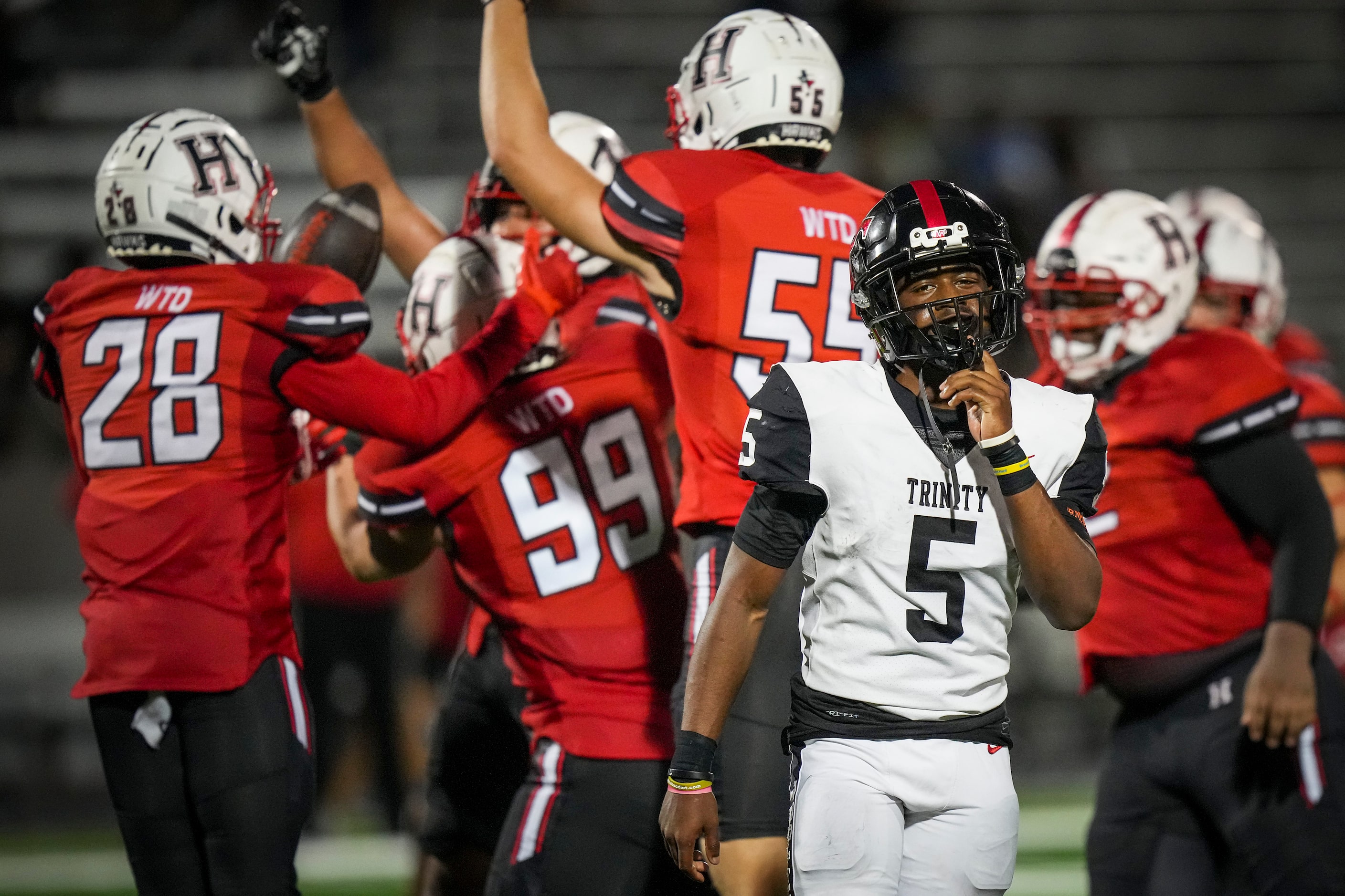 Euless Trinity quarterback Ethan Williams (5) reacts as Rockwall-Heath defensive lineman...