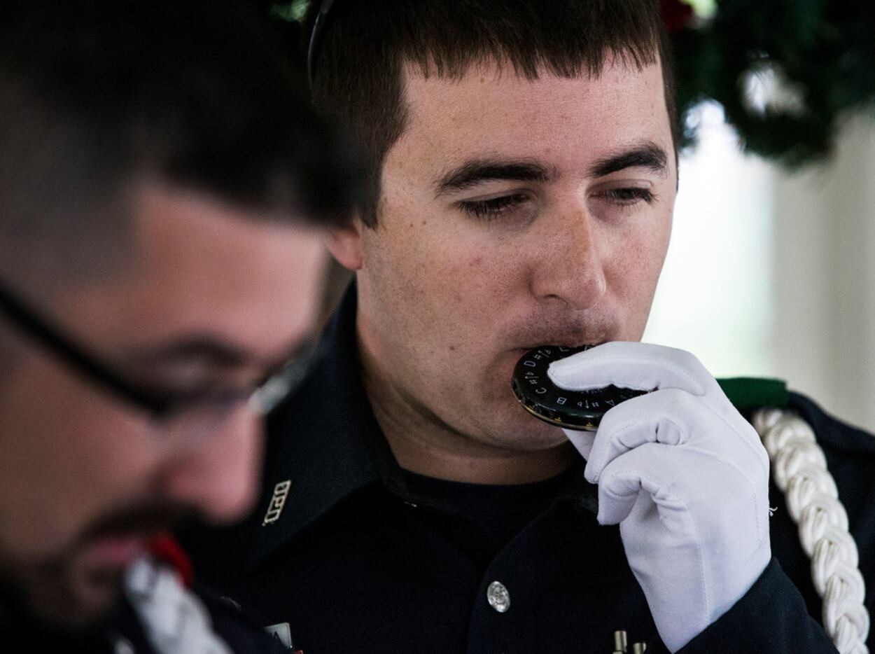 Senior corporal Ryan Cordova, of the Dallas Police Choir, uses a pitch pipe before...