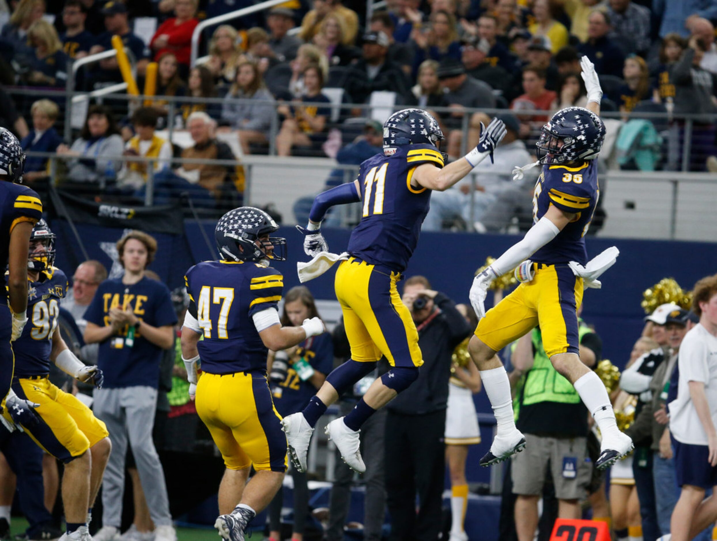 Highland Park's Whit Winfield (11) and Brock Bakich (35) celebrates Winfield's interception...