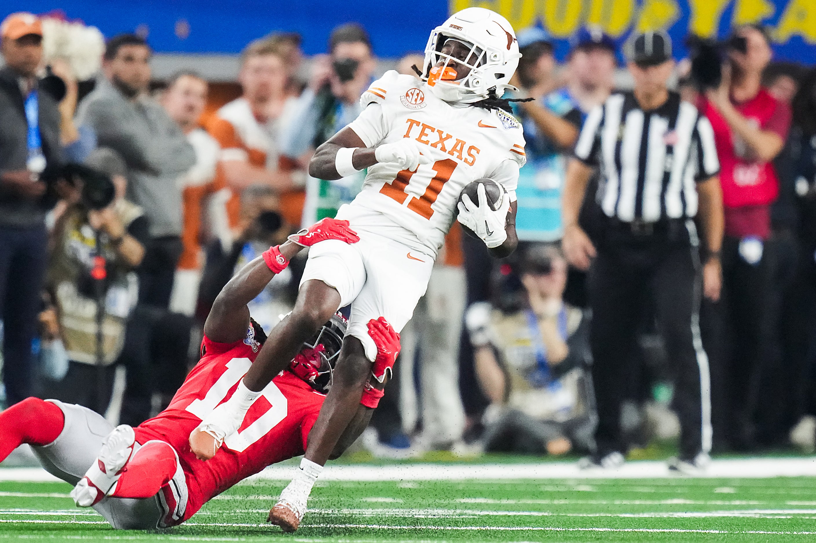 Texas wide receiver Silas Bolden (11) spins away from Ohio State cornerback Denzel Burke...