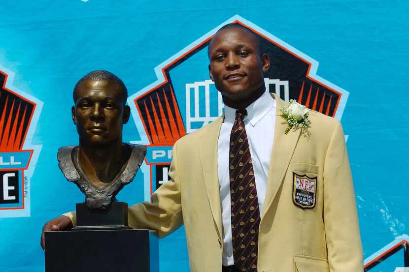Pro Football Hall of Fame enshrinee Barry Sanders stands with his bust during the 2004 NFL...