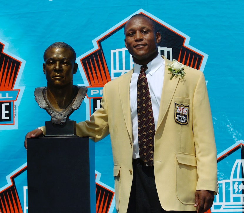 Pro Football Hall of Fame enshrinee Barry Sanders stands with his bust during the 2004 NFL...