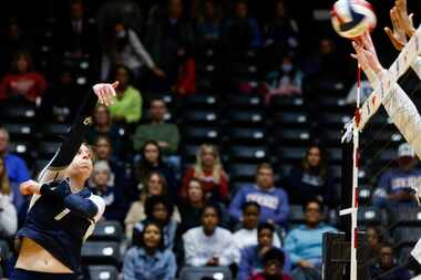 Keller junior Reagan Sharp (7) spikes the ball toward Katy Tompkins defenders during their...