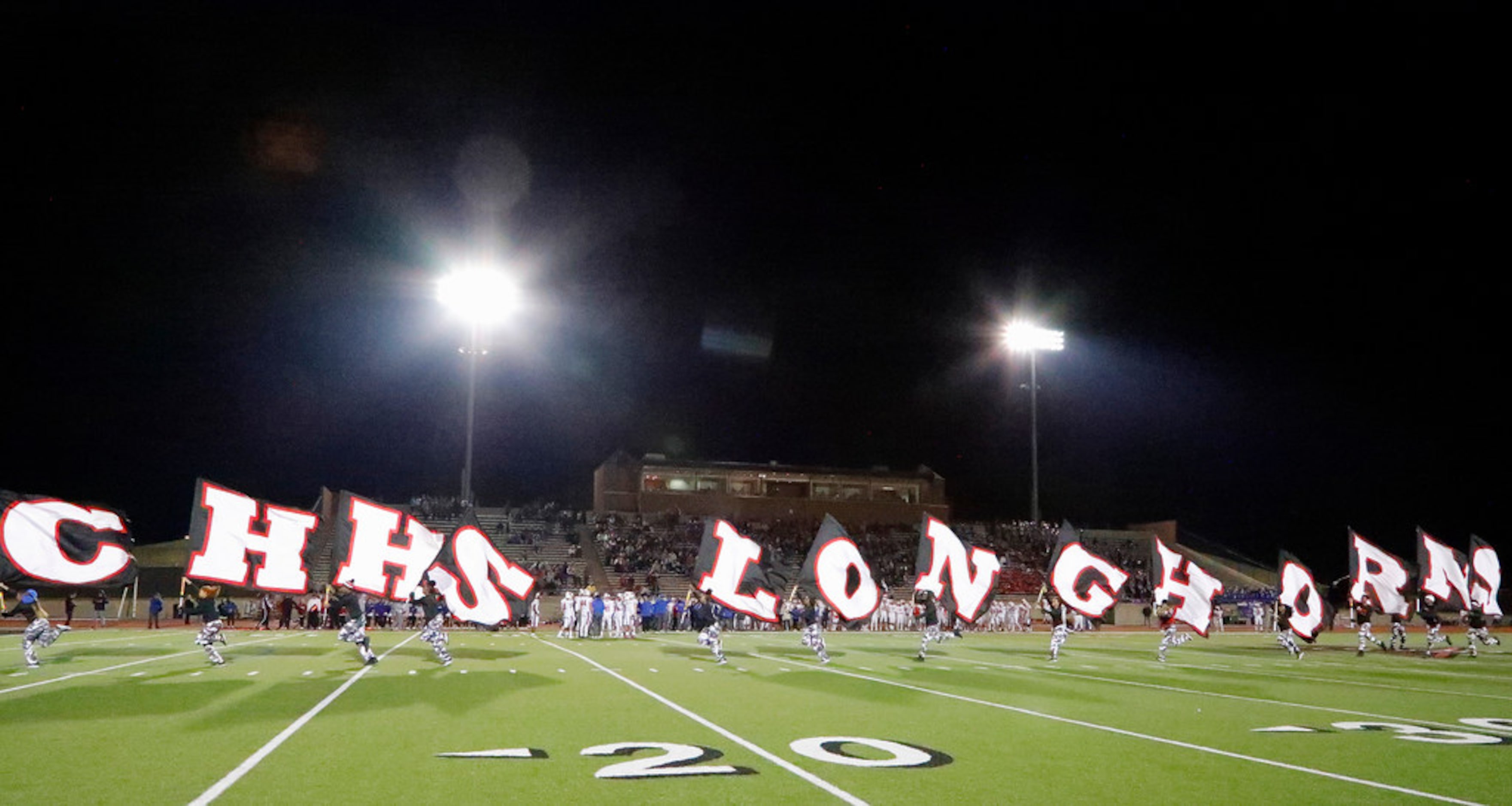 Cedar Hillâs spirit team racas across the field after a touchdown in the first half as...