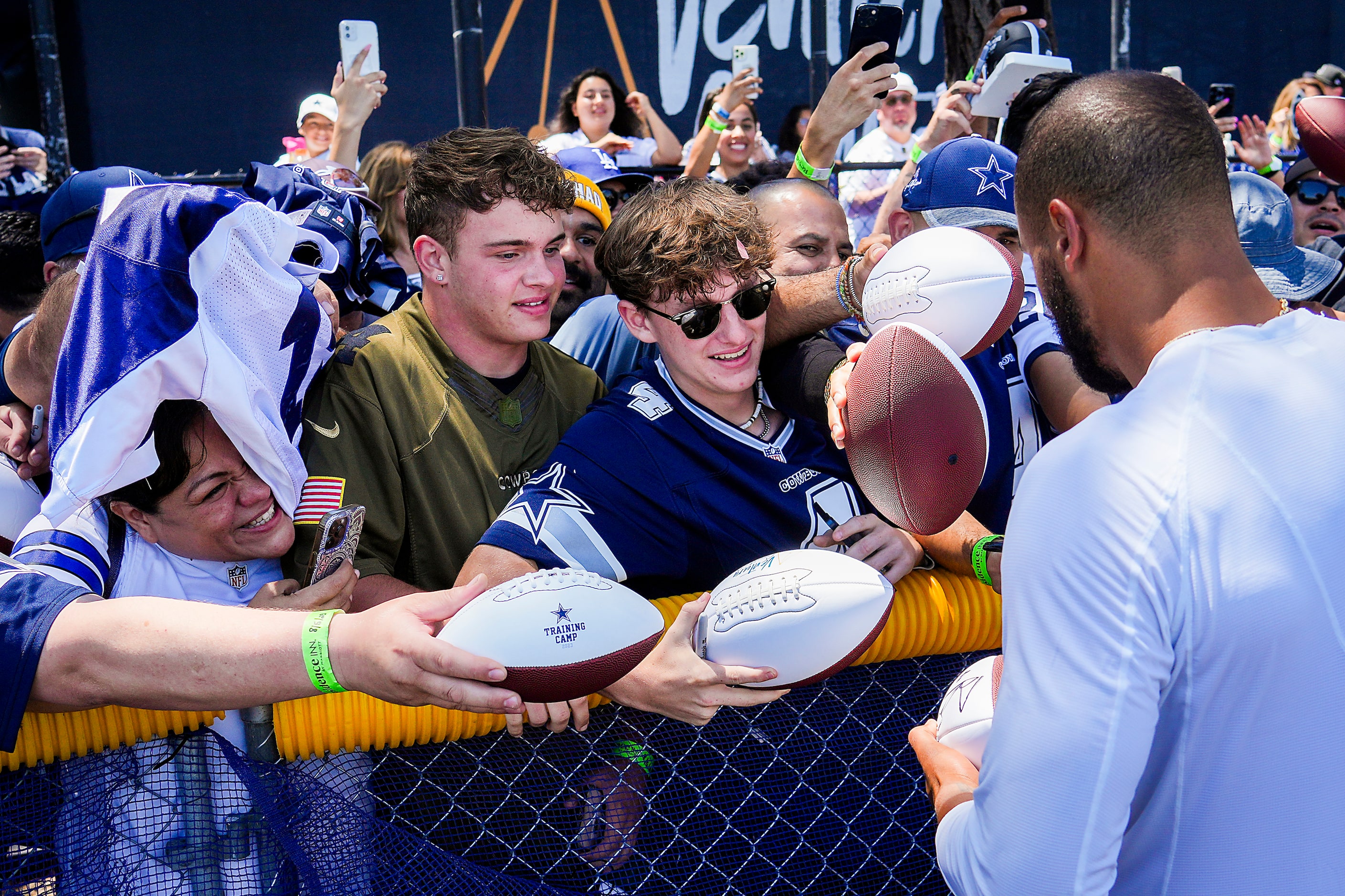 Dallas Cowboys quarterback Dak Prescott (4) signs autographs for fans following a training...