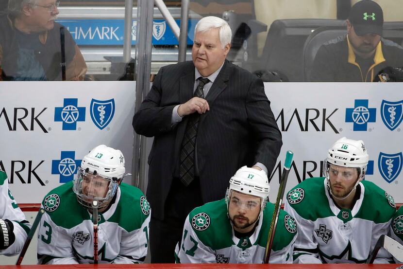 Dallas Stars head coach Ken Hitchcock stands behind his bench in the third period of an NHL...