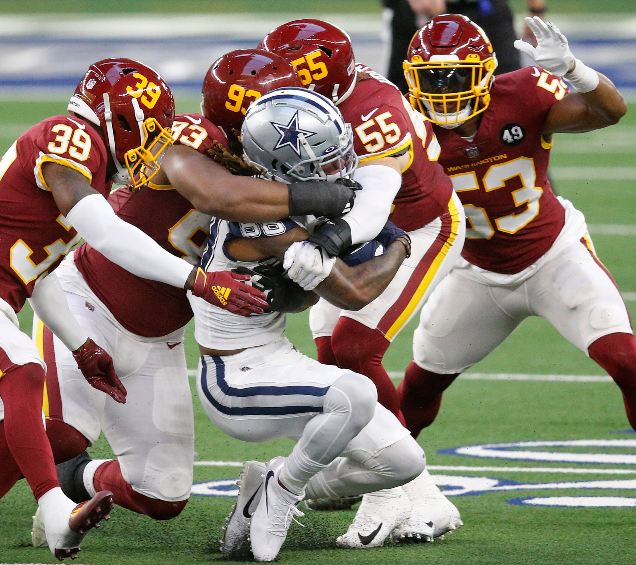 Dallas Cowboys wide receiver CeeDee Lamb (88) is wrapped up by the Washington Football Team...