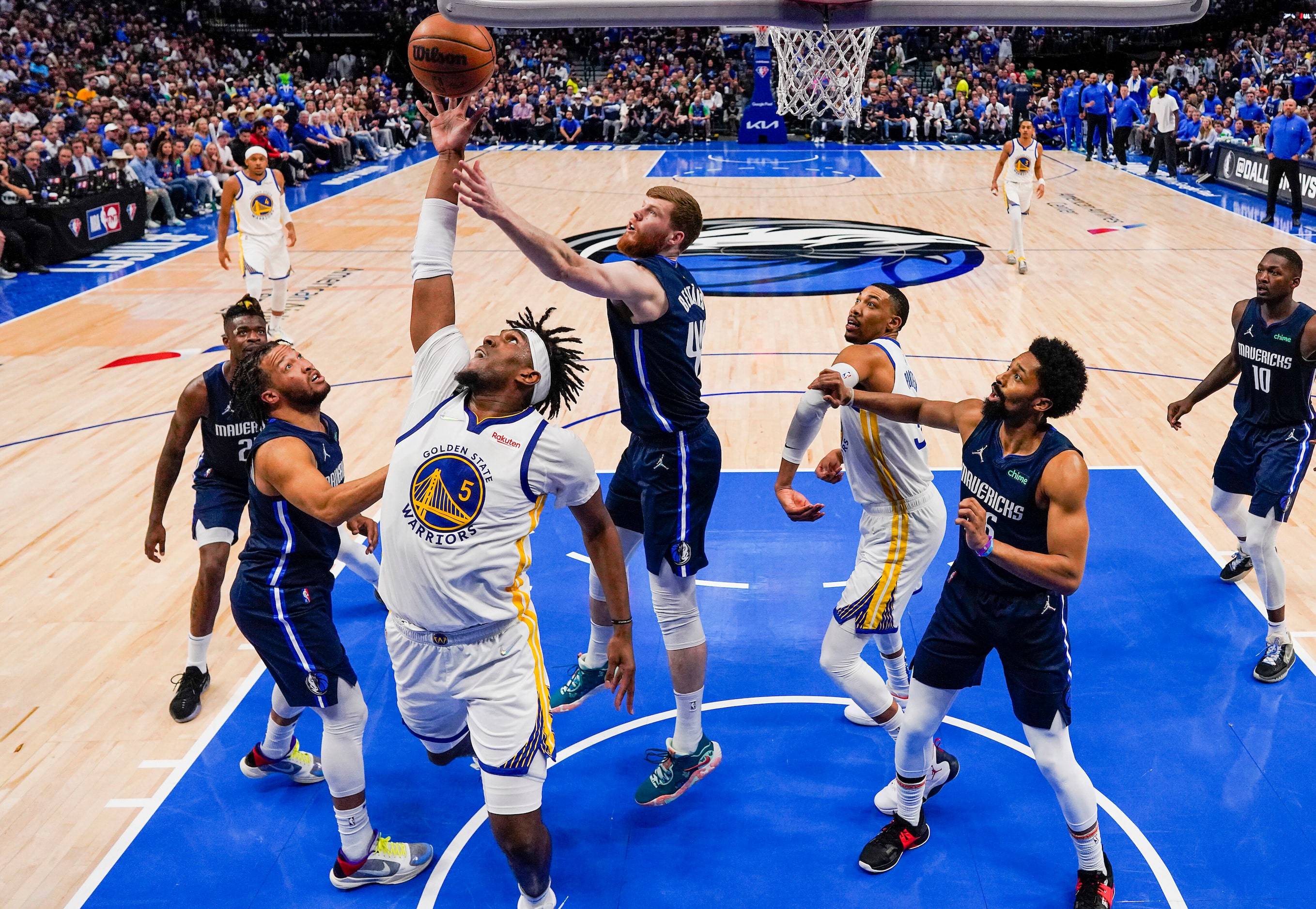 Golden State Warriors center Kevon Looney (5) reaches for a rebound against Dallas Mavericks...