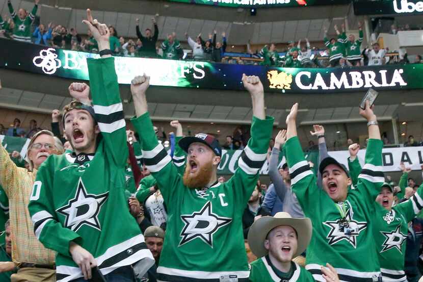 Dallas Stars fans celebrate after the Stars scored during the second period of an NHL hockey...