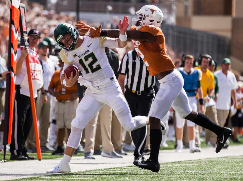 FILE - Baylor Bears quarterback Charlie Brewer (12) is pushed out of bounds by Texas...