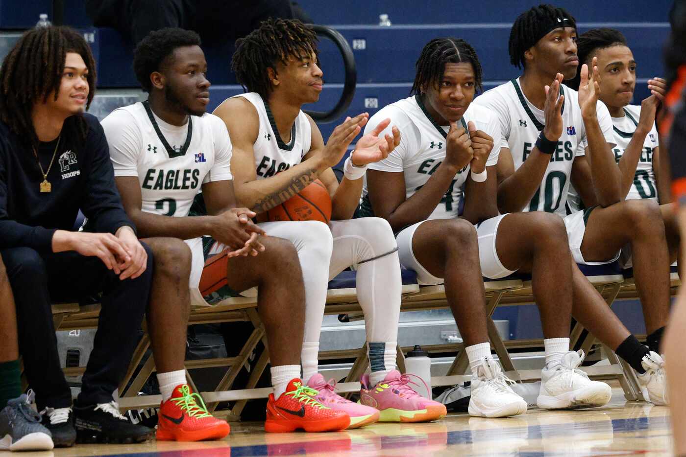 Mansfield Lake Ridge players clap after a three-pointer during the second half of a...