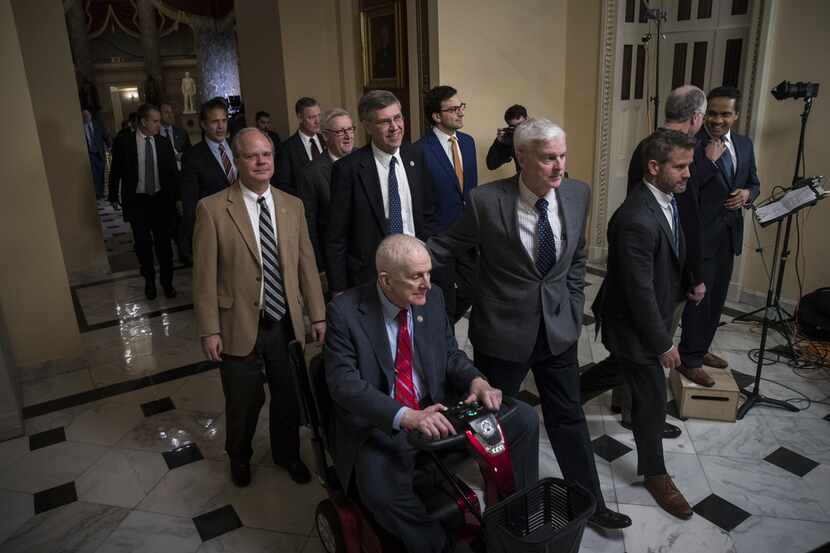 A group of House members walk to the House floor to vote on the continuing resolution to...