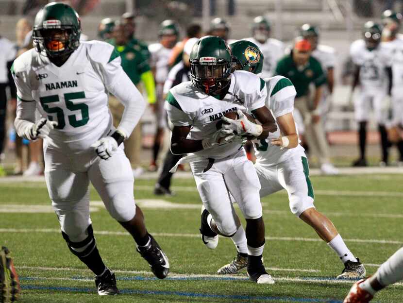 Naaman Forest RB Kingsley Bennett (2) picks up a couple of yards during the first half of...