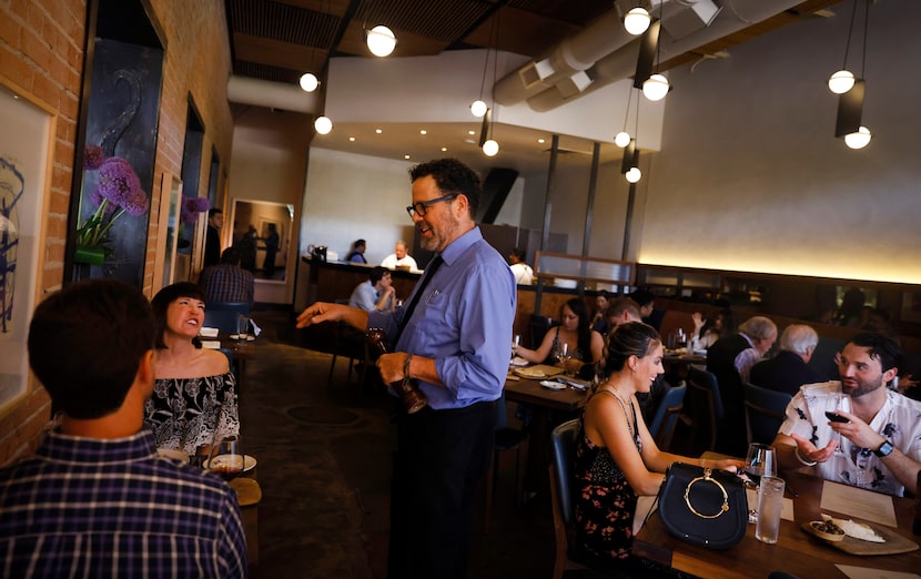 Server David Walsh waits on a table at the nearly full Nonna restaurant in Dallas.