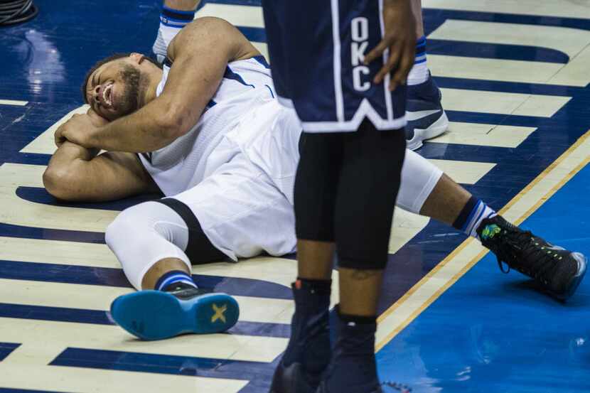 Dallas Mavericks guard Justin Anderson (1) falls to the ground after Oklahoma City Thunder...